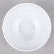 A white Elite Global Solutions melamine bowl with a circular center on a gray surface.
