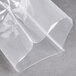 A plastic wrapper of ARY VacMaster chamber vacuum packaging pouches on a grey surface.
