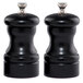 Two black Chef Specialties Capstan pepper mills on a white counter.