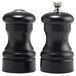 Two black Chef Specialties pepper mills with silver caps.