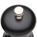 A Chef Specialties black pepper mill with a silver button.