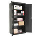 A black metal Alera storage cabinet with shelves and boxes.