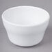 An Elite Global Solutions white melamine bowl on a gray background.