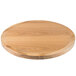 A BFM Seating natural ash veneer round table top on a wooden table.