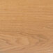 A close-up of a BFM Seating natural ash veneer table top with wood grain.