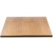 A close-up of a BFM Seating square natural ash veneer table top.