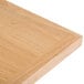 A close up of a BFM Seating natural ash veneer table top.