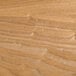 A close-up of a BFM Seating natural veneer wood table top with a wood grain.