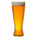 A WNA Comet clear plastic pilsner glass filled with beer and foam.