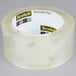 A roll of 3M Scotch clear packaging tape with black and yellow text.