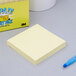 A 3M yellow Post-It note pad.