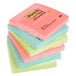 A stack of 3M Post-It Notes in neon green, blue, pink, orange, and yellow.