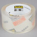 A roll of 3M Scotch clear packaging tape with labels.