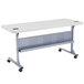A speckled gray rectangular table with wheels.