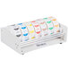 A roll of Noble Products white removable day of the week labels with different colored days of the week on a white background.