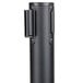 A black metal Aarco crowd control stanchion with a black handle.