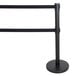 A black Aarco crowd control stanchion with dual black belts on black poles.