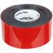 A roll of red 3M Scotch Mounting Tape with a white label with black text.