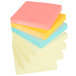 A stack of 14 Post-It note pads with yellow and neon colored paper on top.