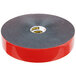 A roll of 3M Scotch black tape with red and black text on a grey background.
