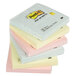 A stack of 3M Post-It fan-folded sticky notes in pastel colors.