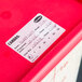 A red Cambro container with a Cambro dissolvable product label.