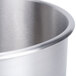 A close-up of a stainless steel Robot Coupe bowl with a lid.