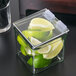 A Cal-Mil glass container with a lime wedge inside.