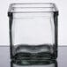 A square glass container with a square bottom.