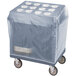 A slate blue plastic covered box on a Cambro cart with a white cover.