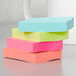 A stack of 3M Cape Town Collection Post-It Notes on a table.