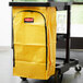 A yellow Rubbermaid high capacity vinyl bag on a cart.