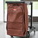 A brown Rubbermaid high capacity vinyl-lined canvas bag on a black cart.