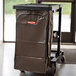 A brown vinyl bag on a black Rubbermaid janitor cart.