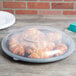 A Fineline black plastic catering tray with croissants on it.