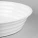 A close-up of a white Fineline low profile plastic catering bowl.