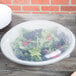 A white Fineline plastic catering bowl with a salad inside and a lid on top.
