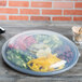 A Fineline black plastic catering tray with 6 compartments holding vegetables.