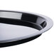 A close-up of a Fineline black plastic catering tray with a high rim.
