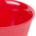 A close up of a red Carlisle Dallas Ware bouillon cup.