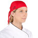 A woman wearing a red Headsweats chef bandana over her hair.