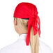 A woman wearing a red Headsweats bandana on her head.