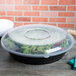 A black Fineline low profile plastic catering bowl with salad in it.
