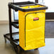 A yellow vinyl bag for a Rubbermaid janitor cart.