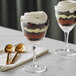 Two Acopa Nick and Nora martini glasses filled with chocolate desserts on a table.
