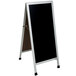 An Aarco aluminum A-frame sign board with a black write-on board.