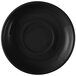 A close-up of a black Tuxton china saucer with a circular shape.