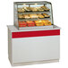 A Federal Industries heated countertop display case full of food.