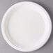 A white Eco-Products compostable sugarcane plate on a gray surface.