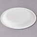 A white Eco-Products compostable sugarcane plate with a circular rim.